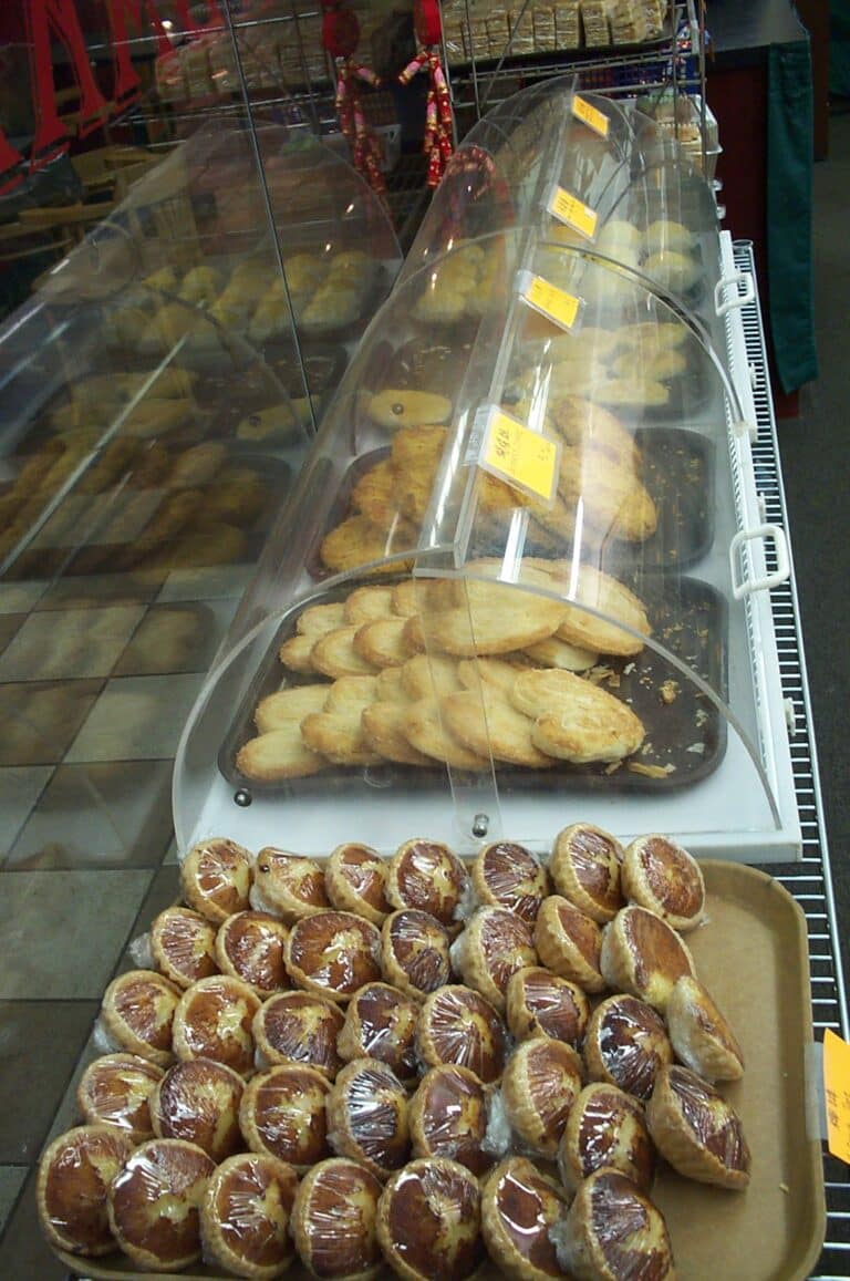 Glass bakery display case filled with cakes and pastries