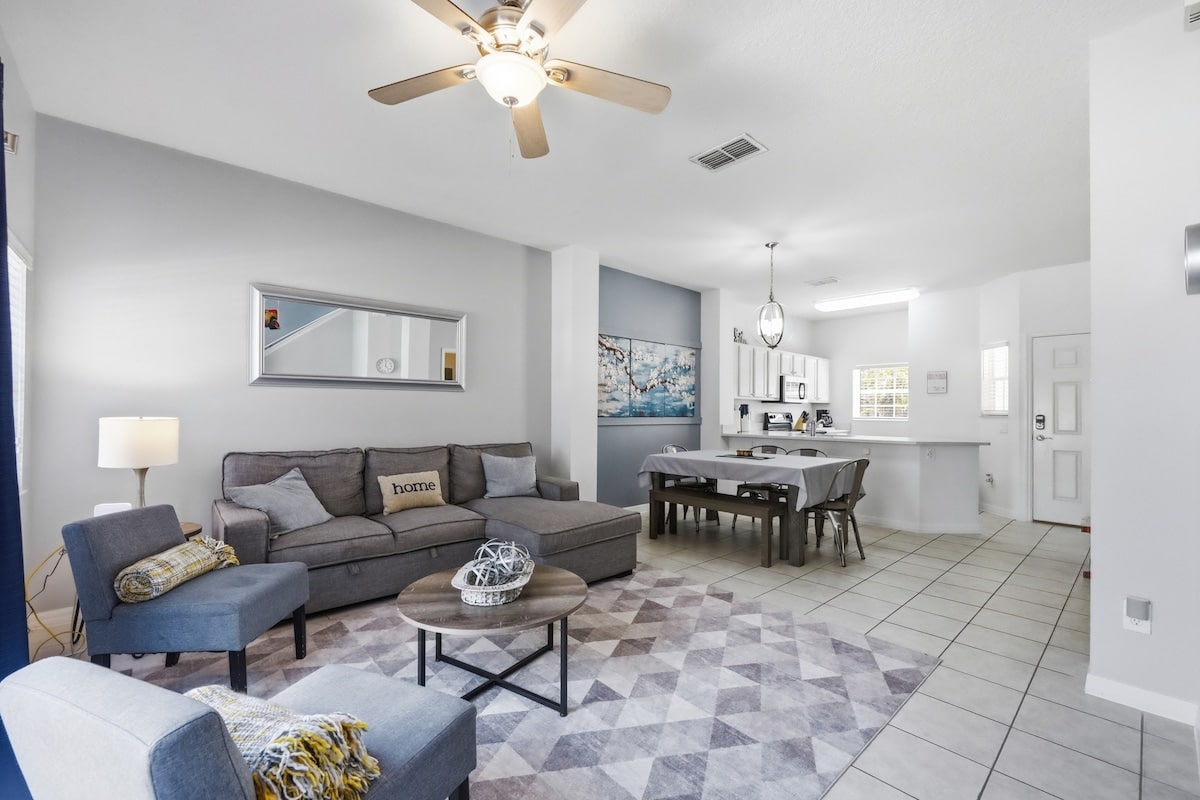 Open main floor with living, dining, and kitchen all in one bright space.