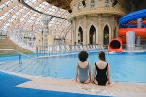 Indoor water park with slides and pool under a glass dome roof